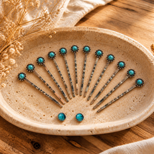 Styled illustration of F31-12E: twelve silver-tone faux-turquoise bobby pins and two matching round 10mm silver-tone stud earrings resting naturally inside a warm cream stone tray