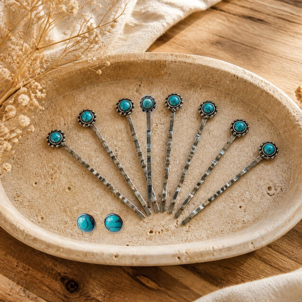 Warm stone-tray styled product composite showing eight silver-tone faux-turquoise bobby pins and two matching 10mm silver-tone stud earrings, exactly what F31-8E includes