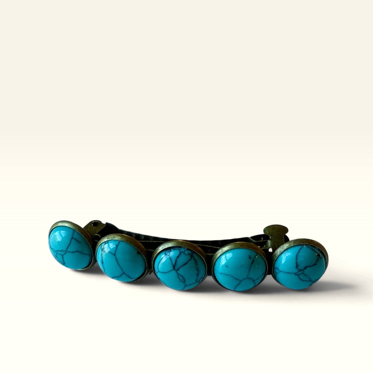 Front angle of one bronze-tone five-stone faux-turquoise western barrette