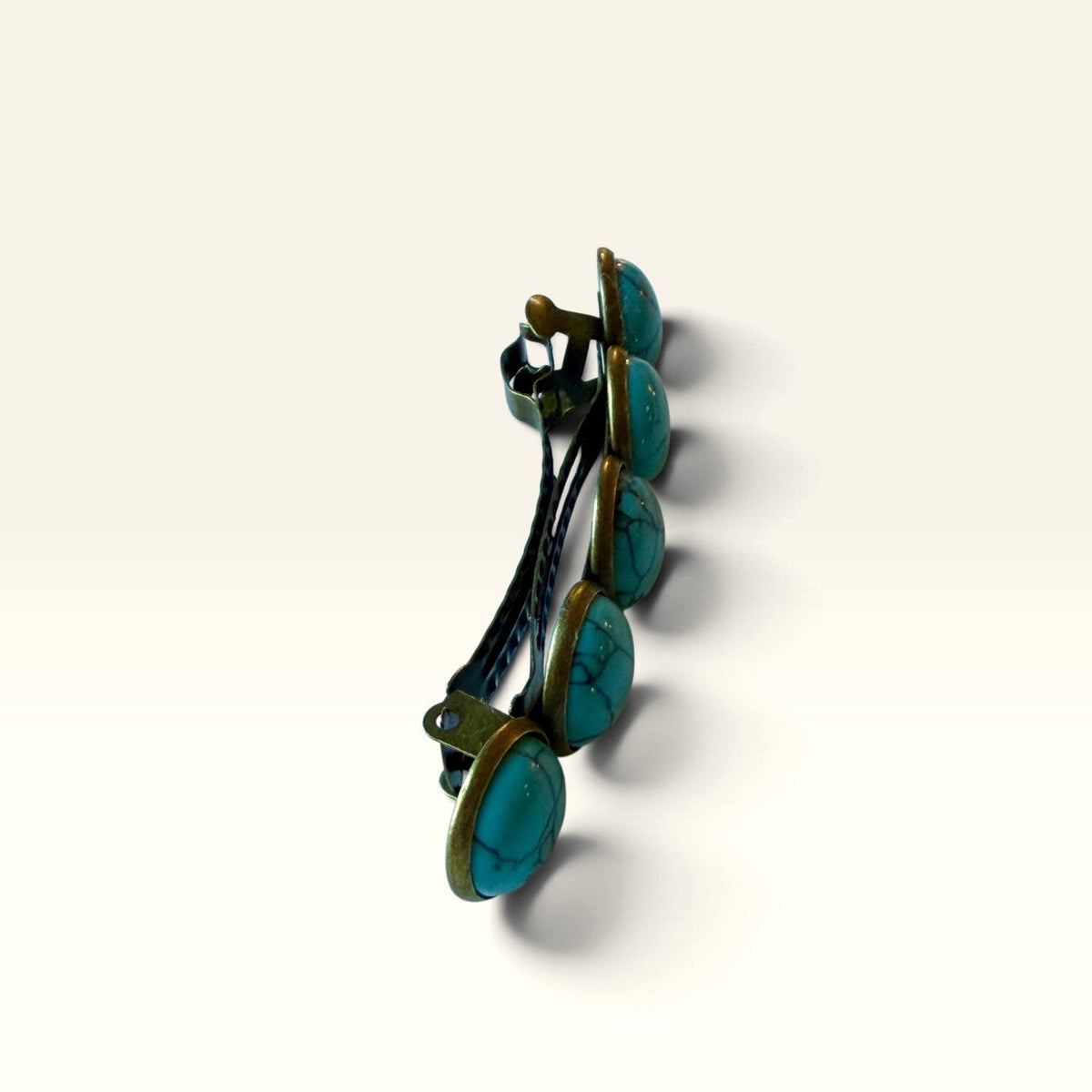 Side profile of western turquoise barrette showing raised stones and metal clasp