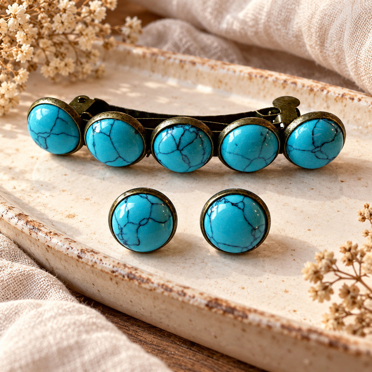 One five-stone bronze-tone turquoise hair barrette and matching pair of stud earrings styled on a neutral tray