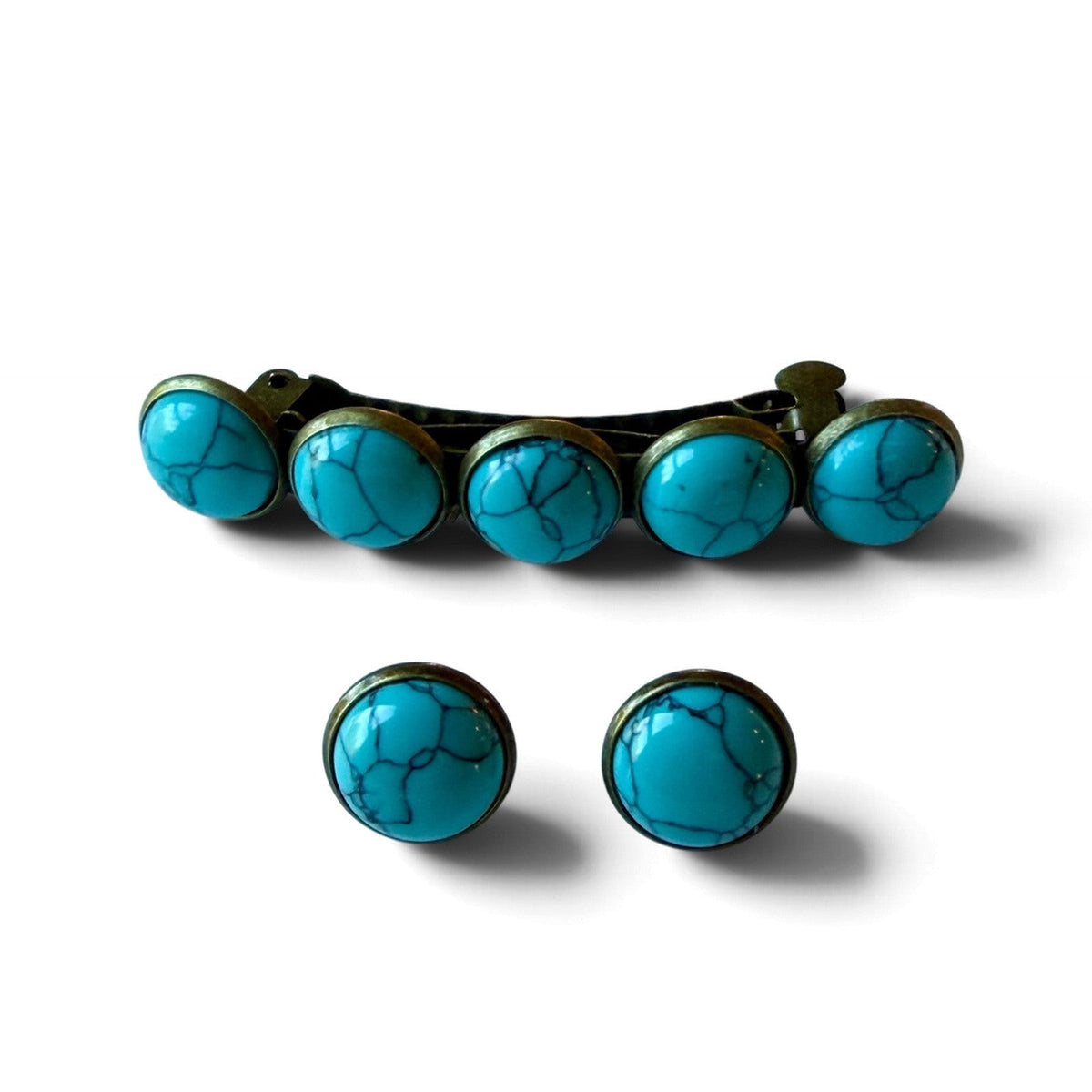 One five-stone turquoise hair barrette and two matching 12mm round turquoise stud earrings on white