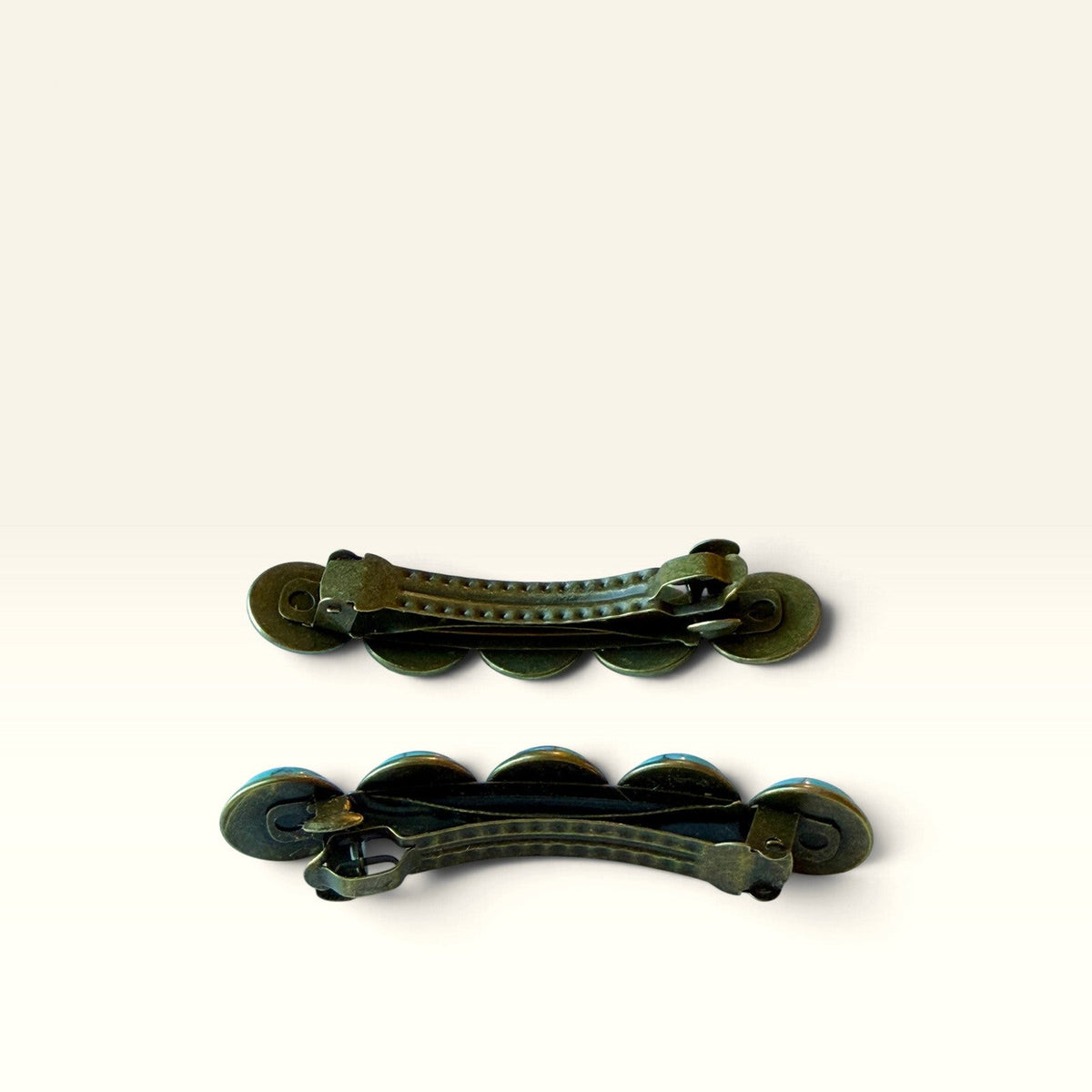 Backside view of two bronze-tone clasp barrettes included in the turquoise gift set
