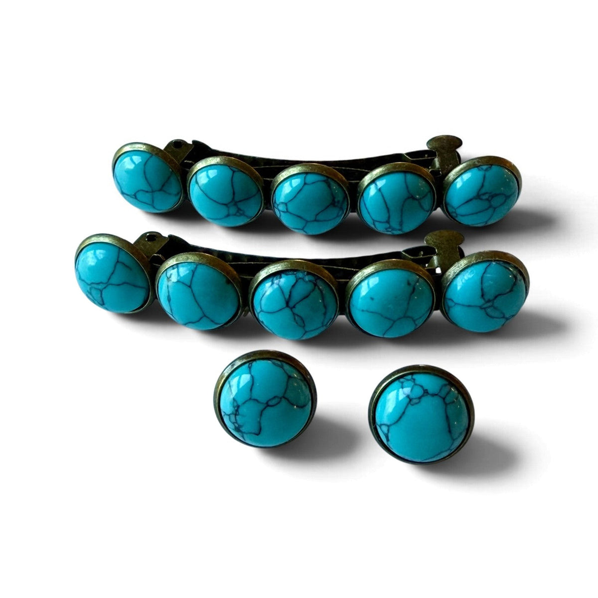 Two five-stone turquoise hair barrettes and two 12mm round turquoise stud earrings on white