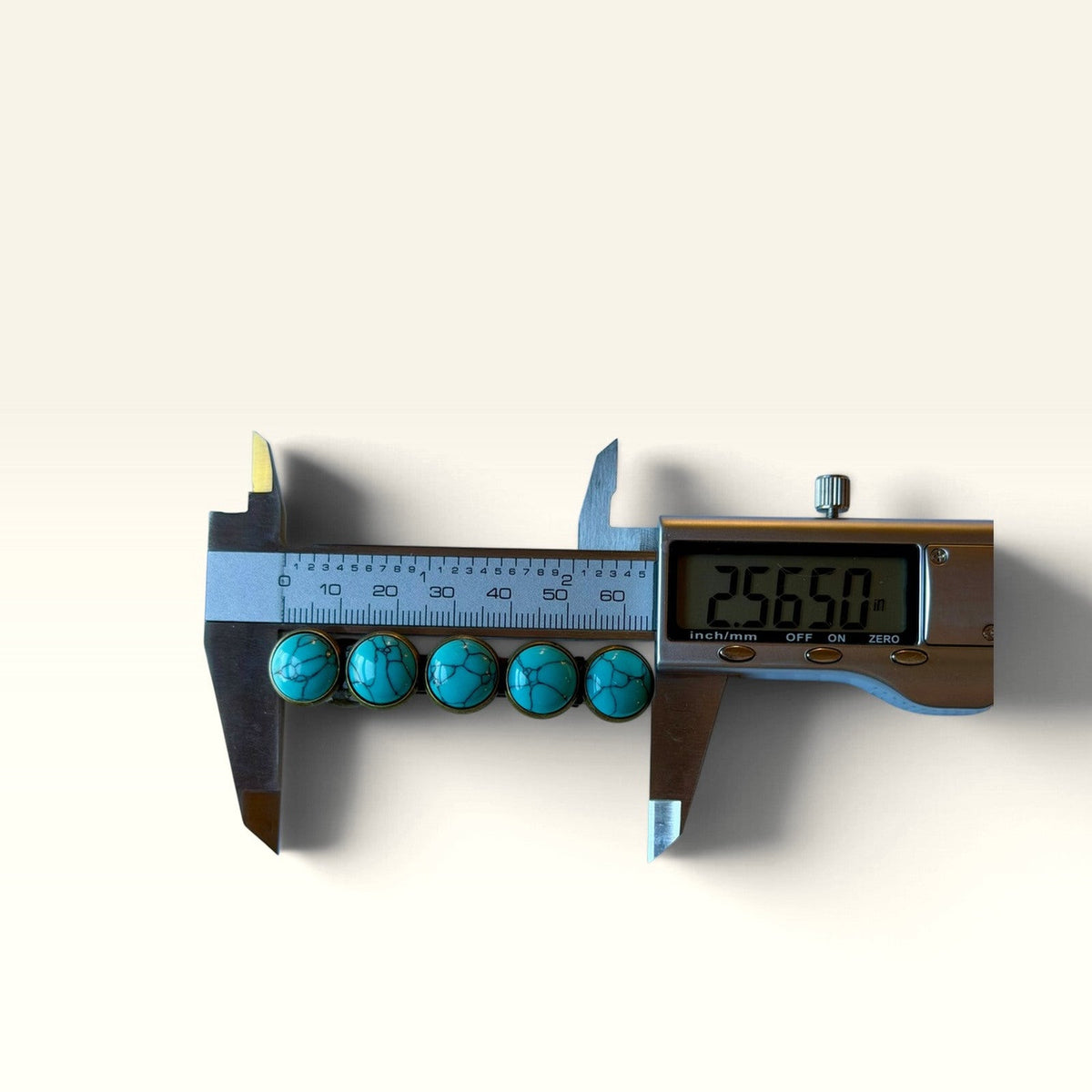 Digital caliper showing length of the five-stone turquoise barrette included