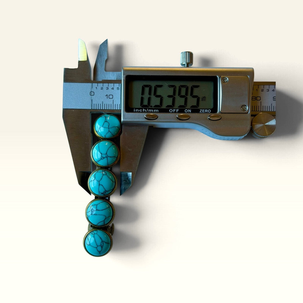 Digital caliper showing width of the decorative five-stone turquoise barrette included