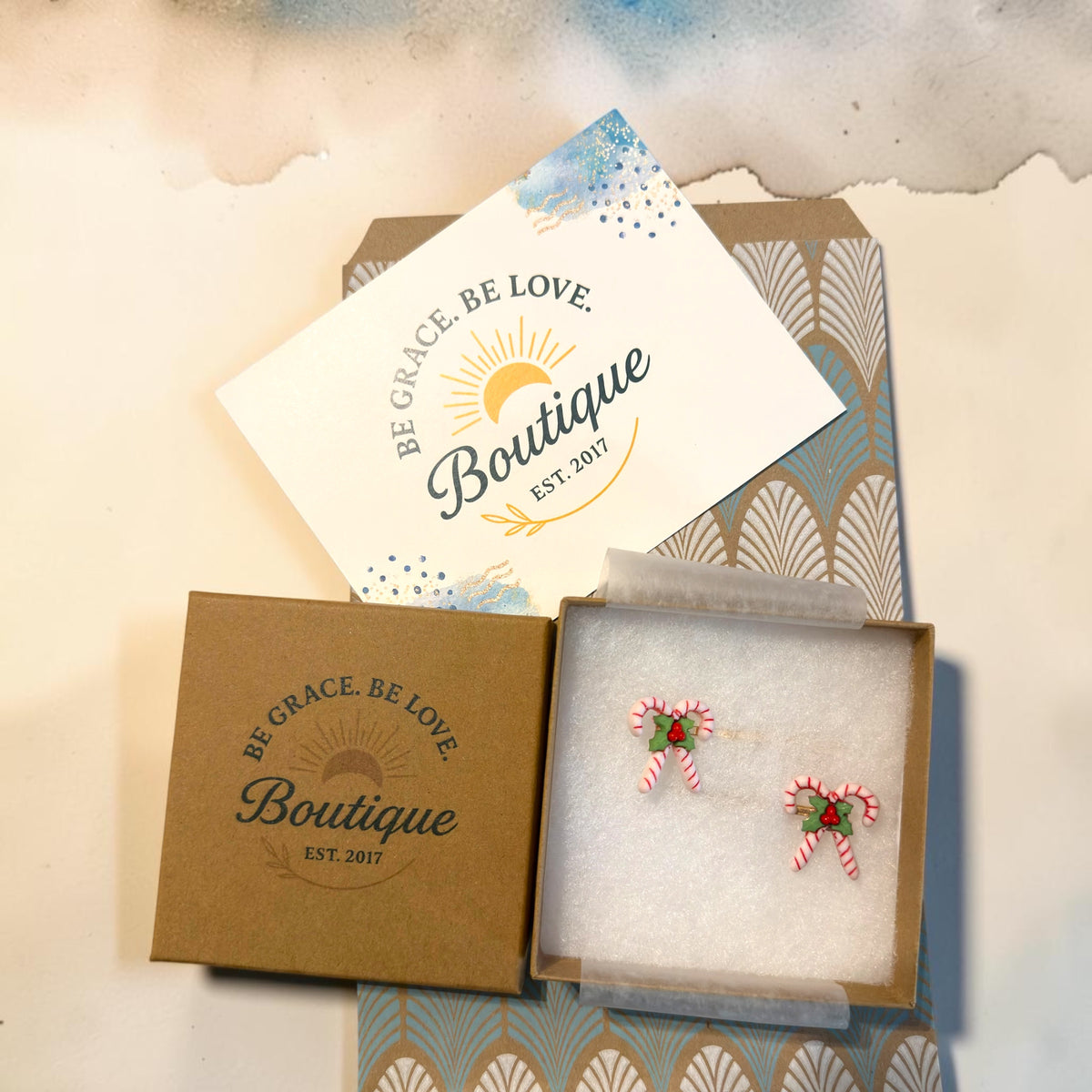 Be Grace Be Love Boutique gift-ready packaging for a set of two candy cane Christmas bobby pins.
