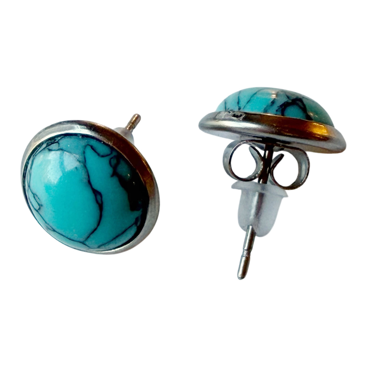 Actual front and back of silver-tone turquoise-style stud earrings showing posts and backs