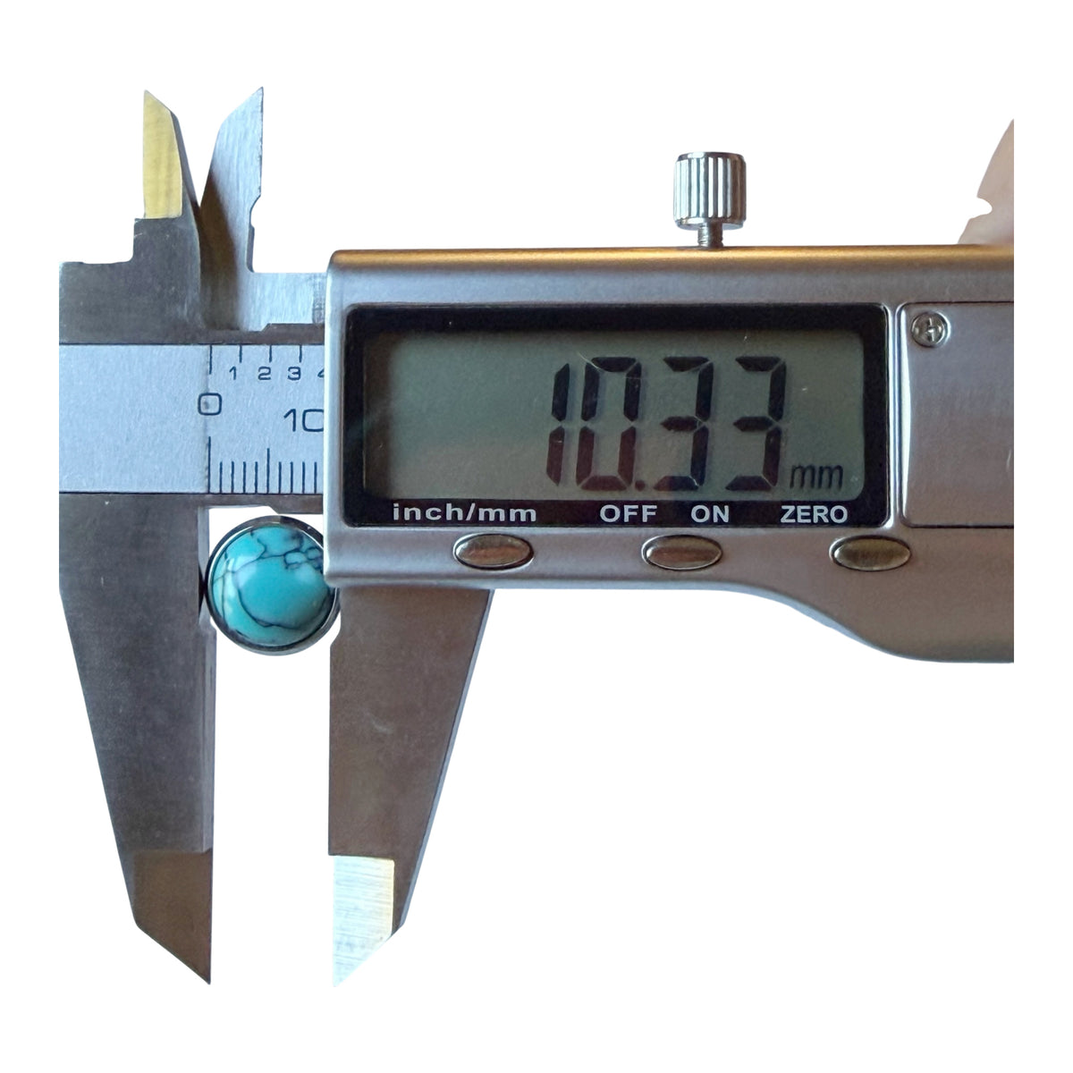 Digital caliper measuring one of the silver-tone faux-turquoise stud earring fronts approximately 10.33 mm