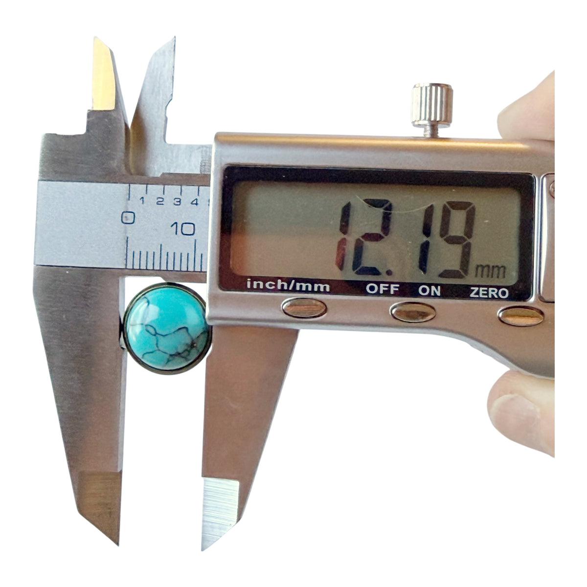 Digital caliper measuring one antique brass-tone turquoise stud front approximately 12.19 mm