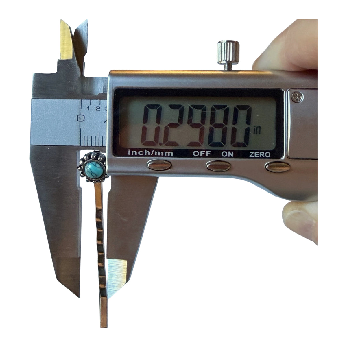 Digital caliper showing width approximately 0.30 inches across the decorative turquoise top of F31 pin