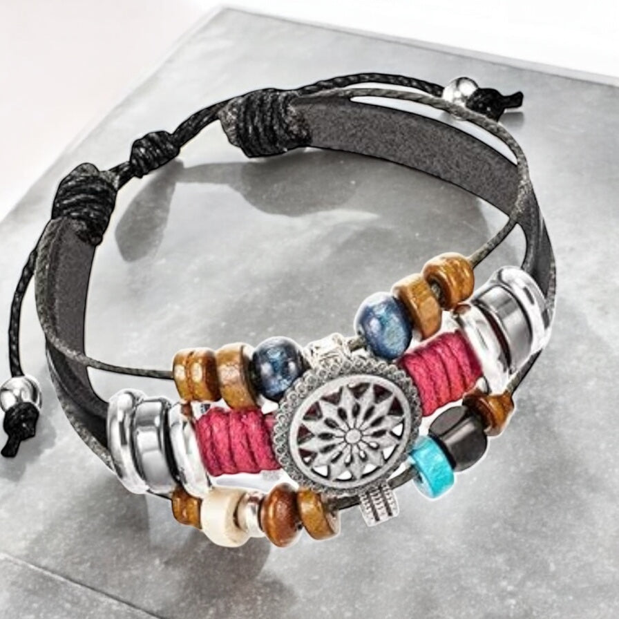 Flat lay of black boho wrap bracelet with faux leather and bead layers