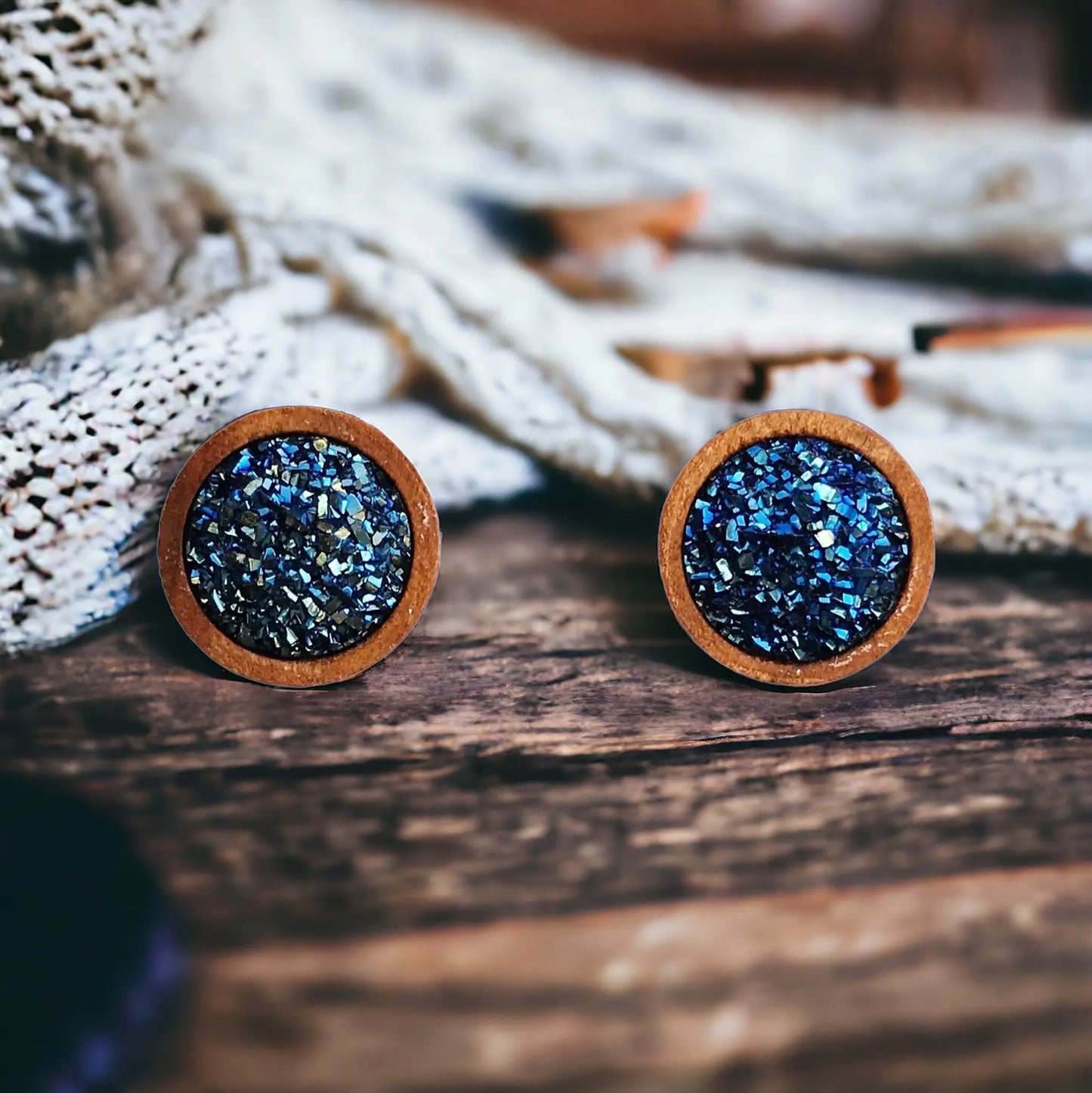 Round blue druzy wood stud earrings displayed on a rustic boho  wood surface
