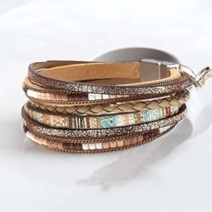 Layered beaded bracelet in earthy colors with braided faux leather strands