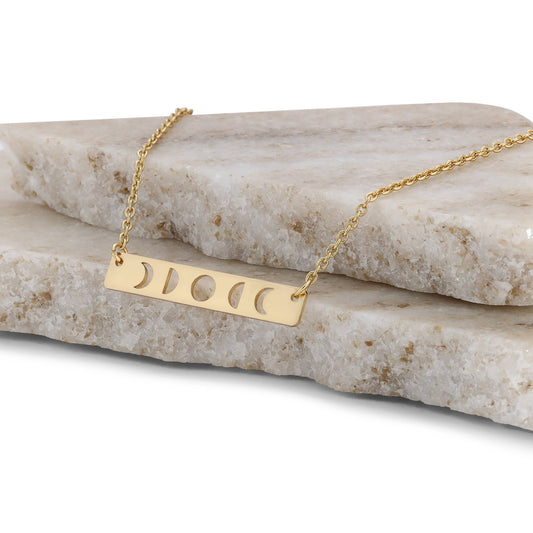 Curated gold moon phase necklace displayed in gift box with celestial vibe
