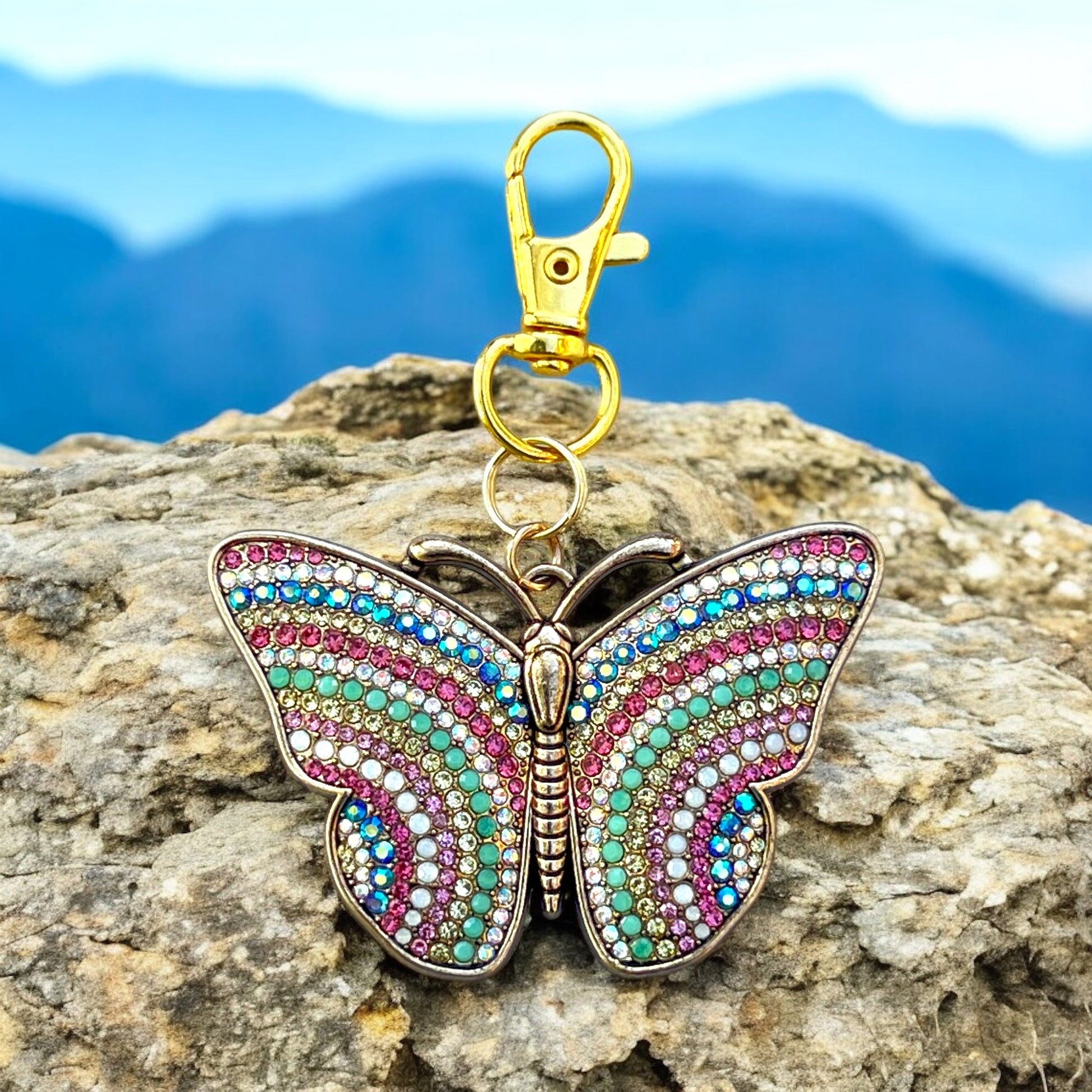 Close-up of colorful rhinestone butterfly keychain with gold metal finish
