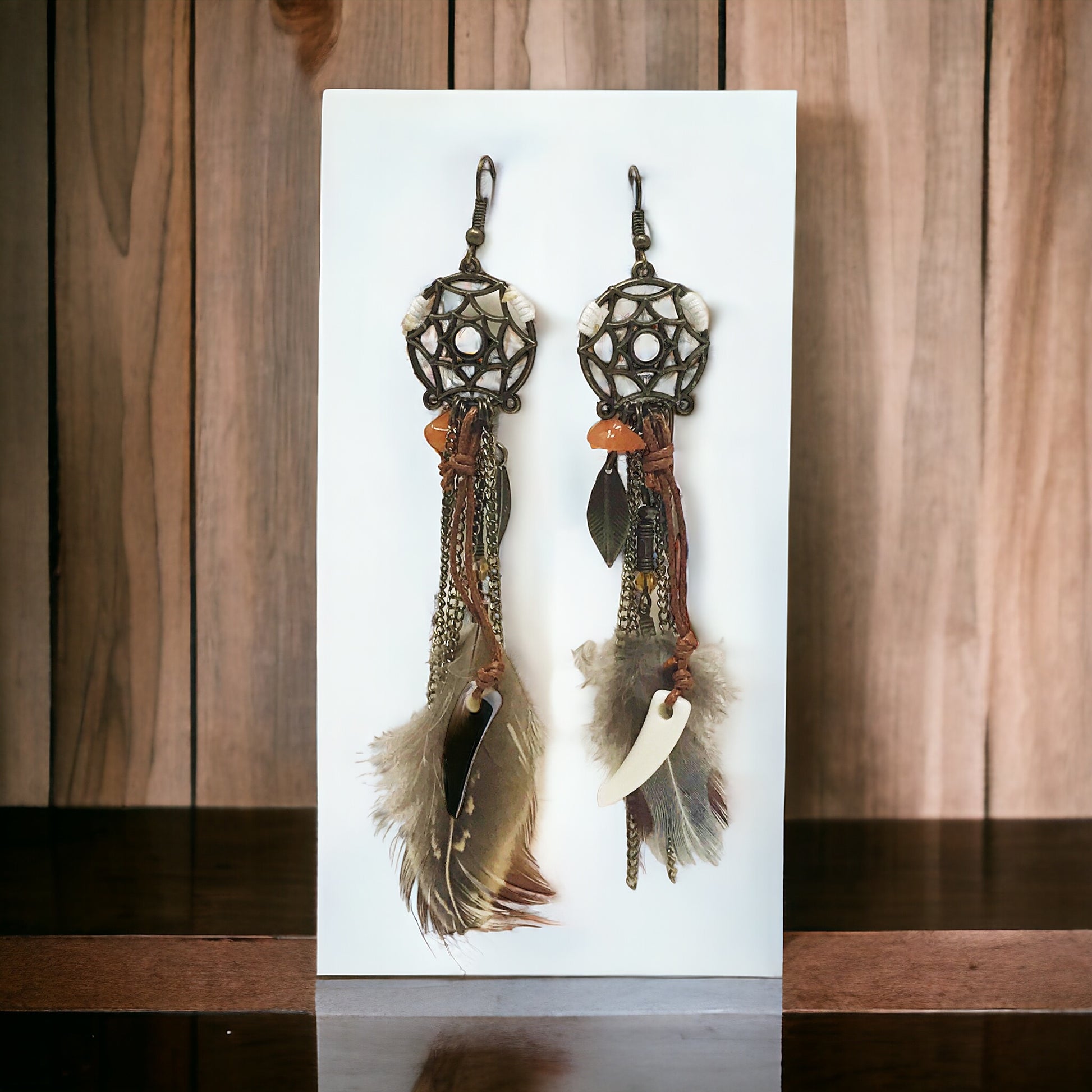 Full view of lightweight dream catcher feather earrings hanging side by side on neutral display
