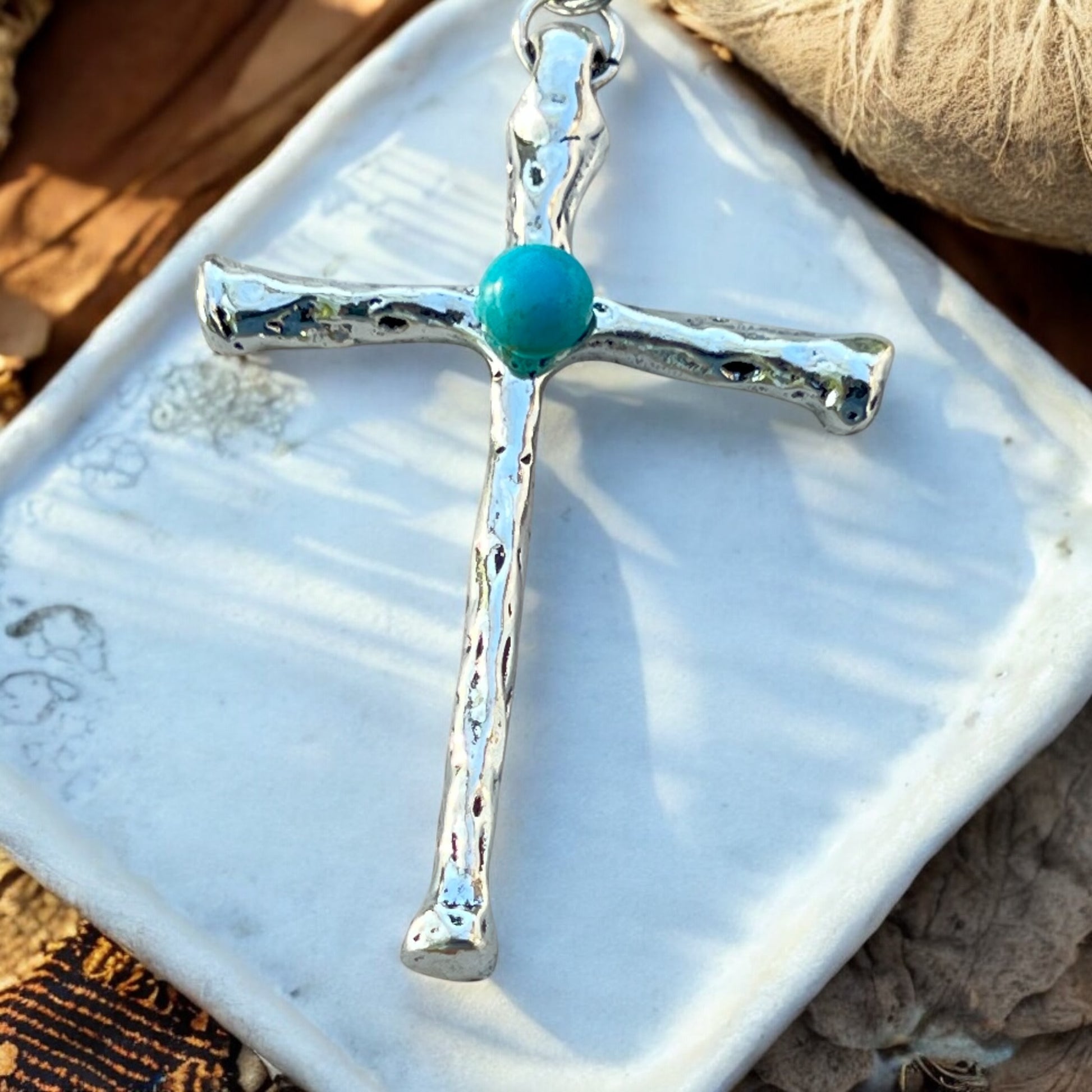 Back of faith cross purse charm showing rustic silver details
