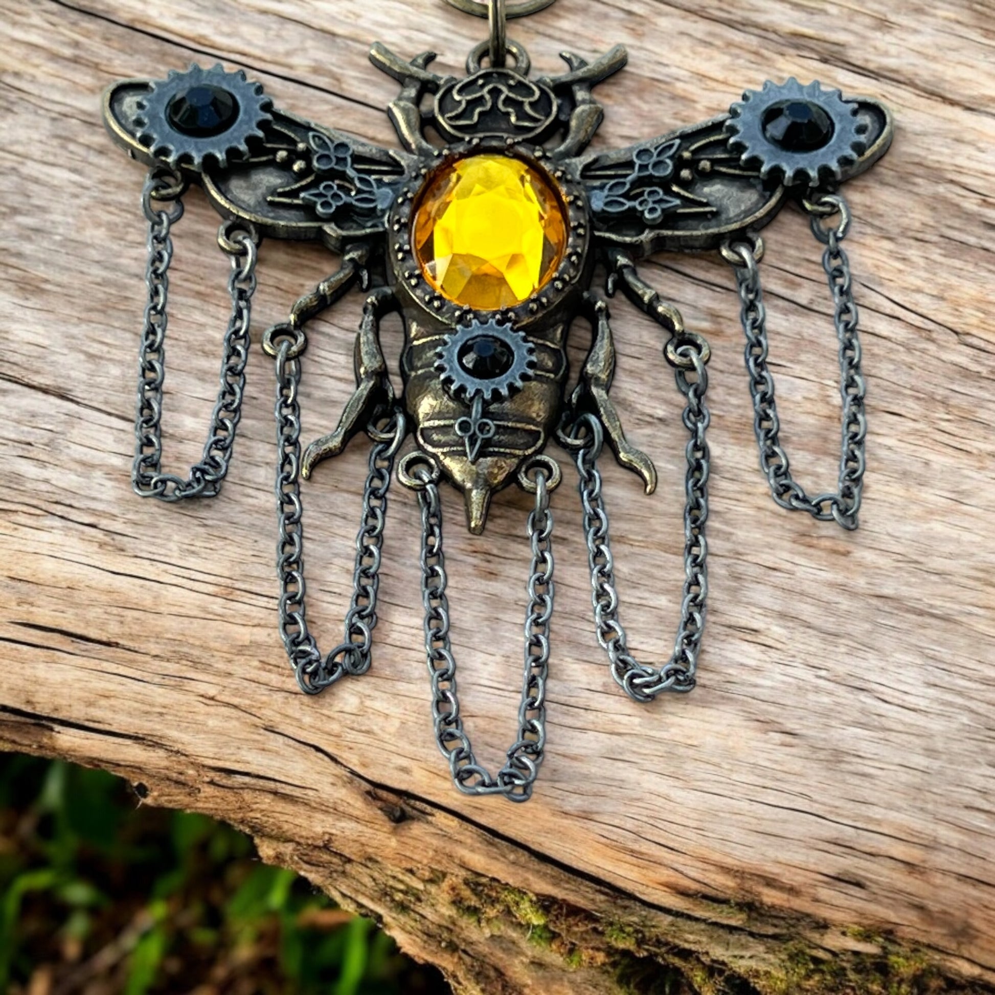 Fantasy bee purse accessory with glowing crystal and bronze finish