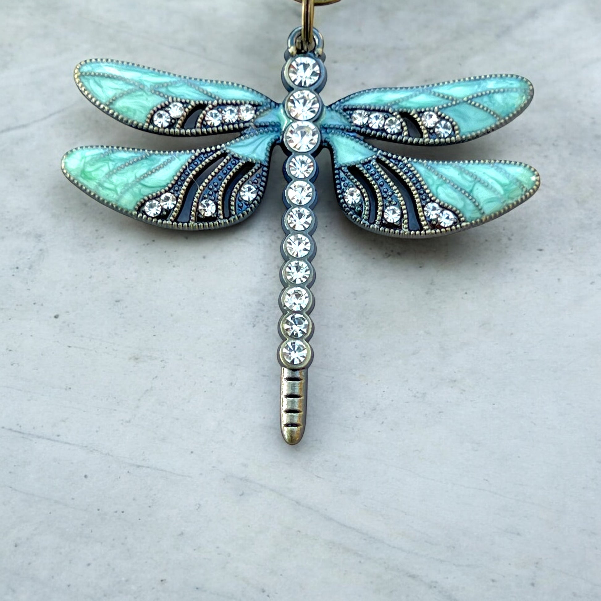 Fantasy-inspired dragonfly keychain with brass and enamel accents