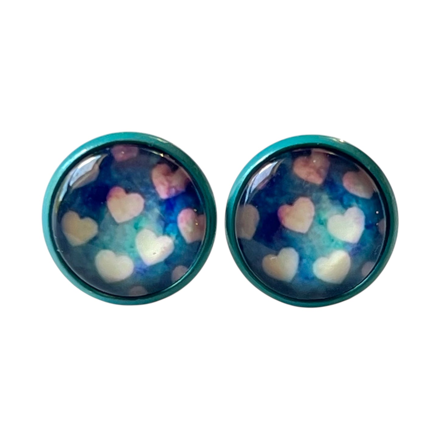 Pair of round earrings with heart pattern on a white background