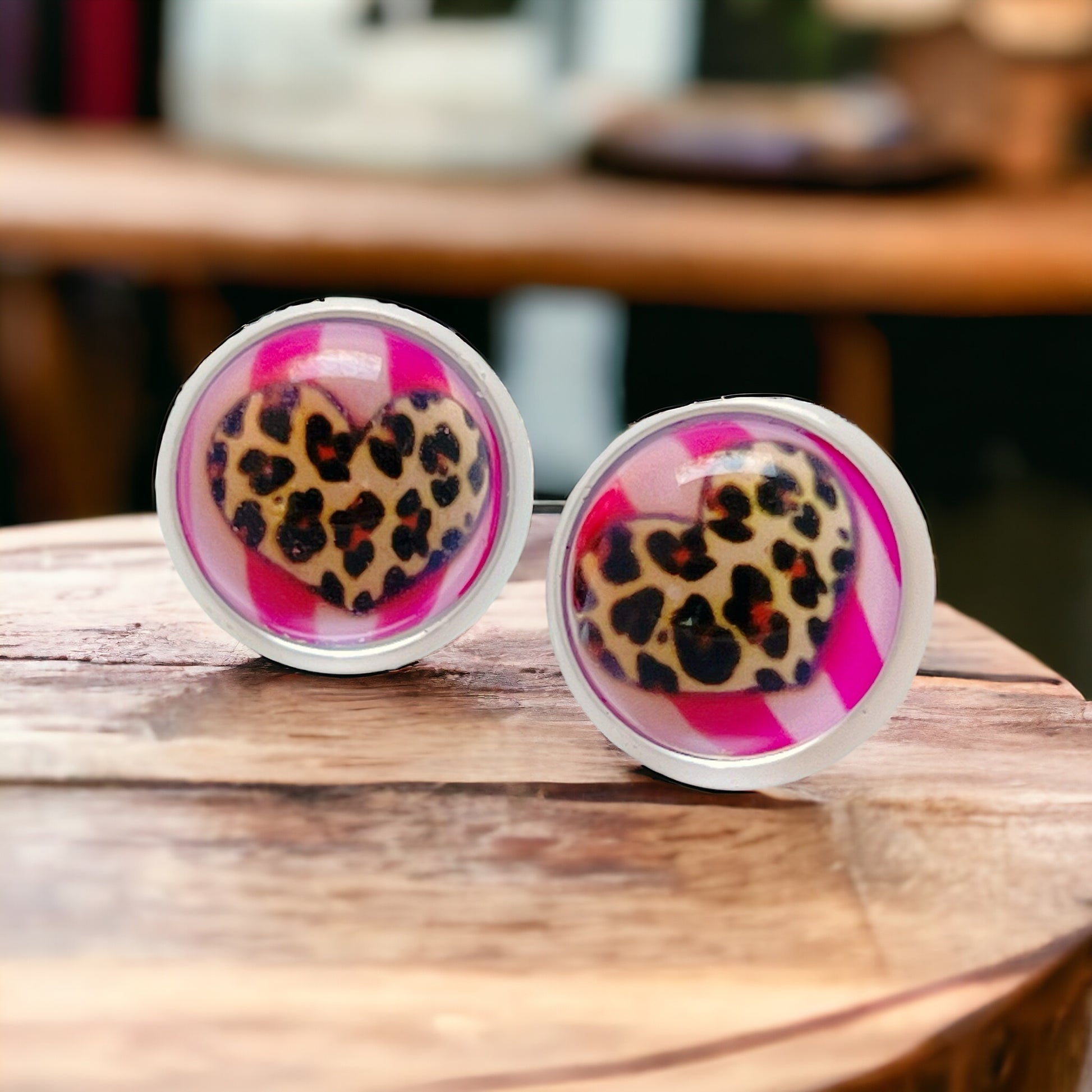 Side view of glass cabochon earrings with animal print heart design