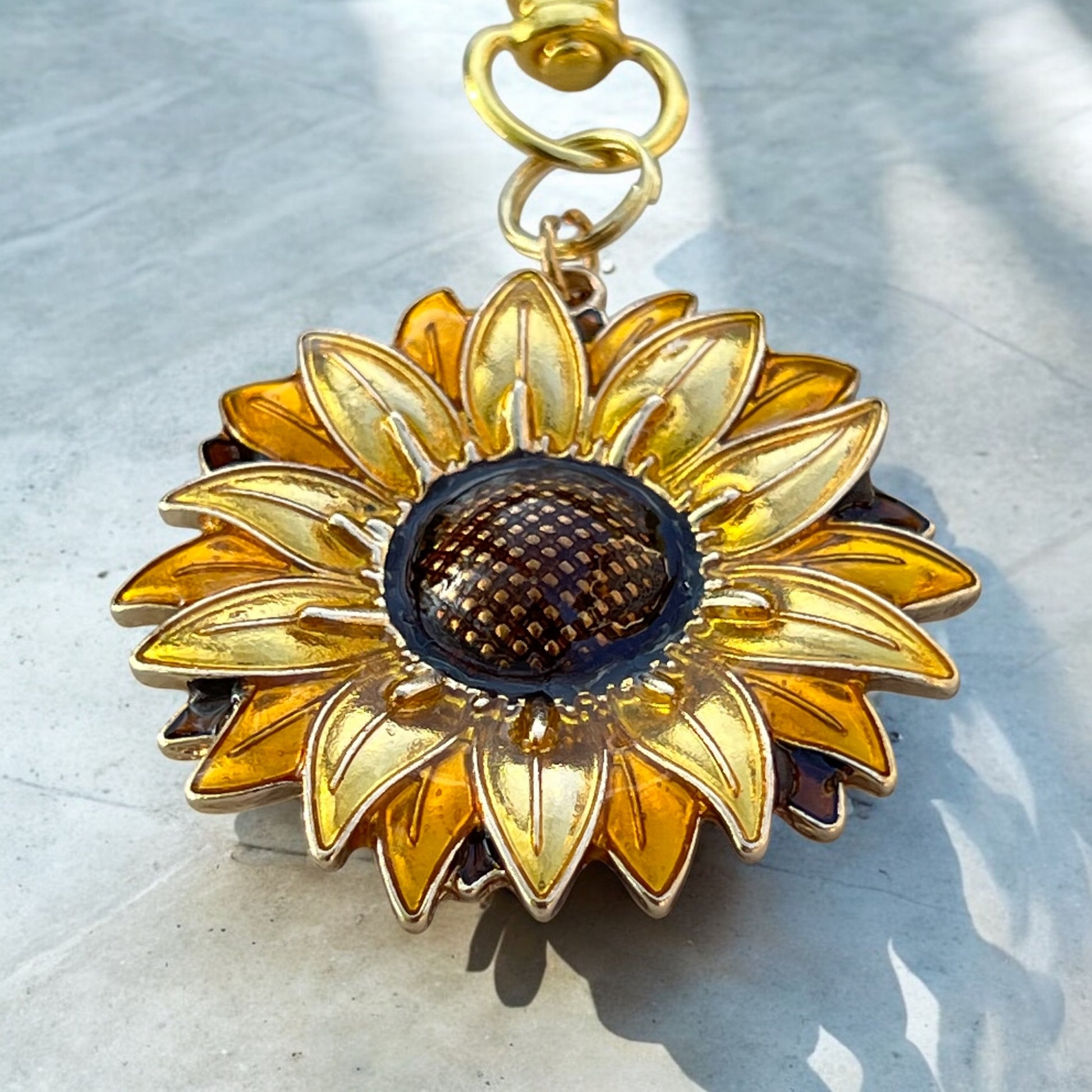 Gold sunflower keychain styled with neutral bohemian accessories