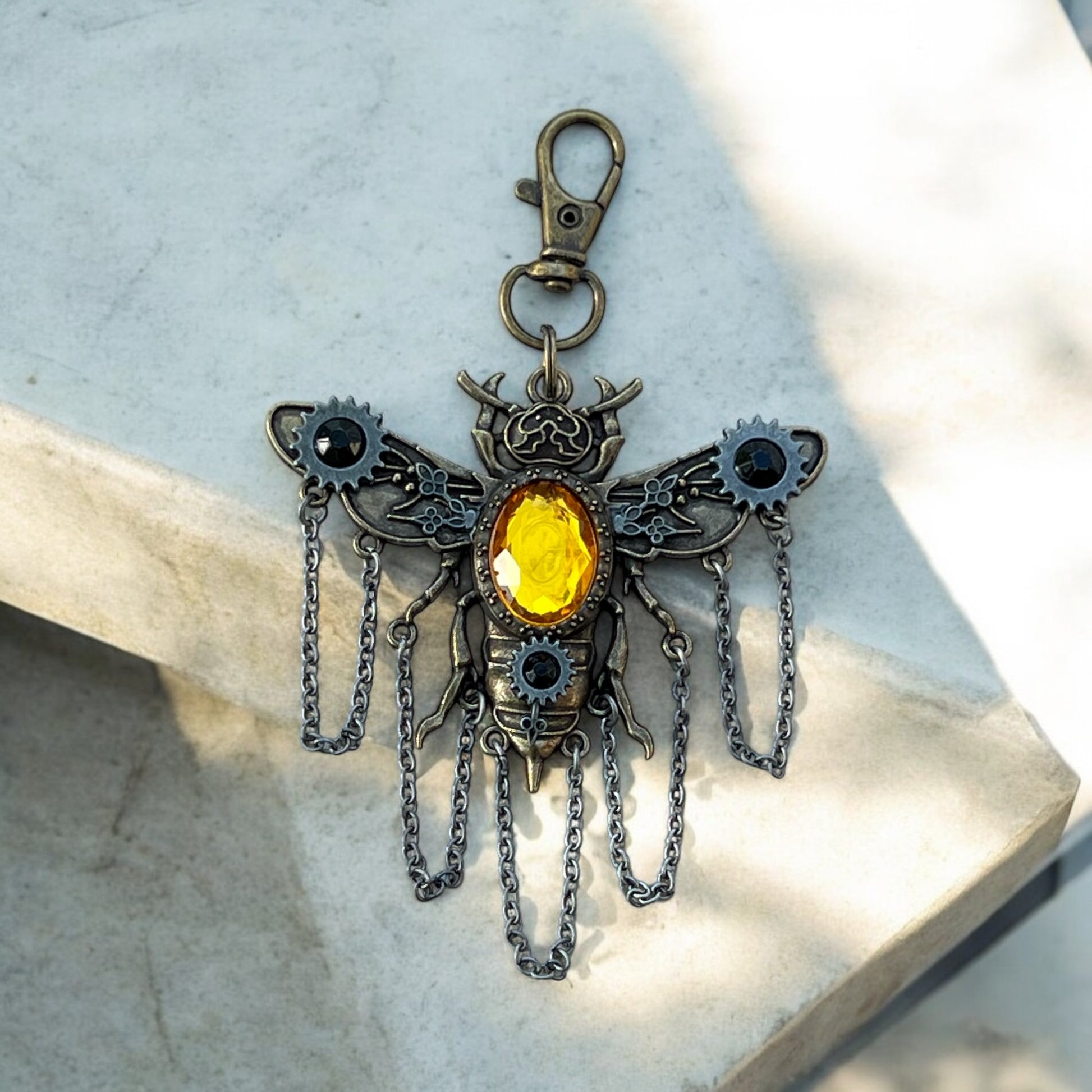 Flat lay of gothic steampunk bee accessory with gear details