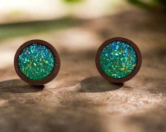 Round green druzy wood stud earrings displayed on a rustic wood surface