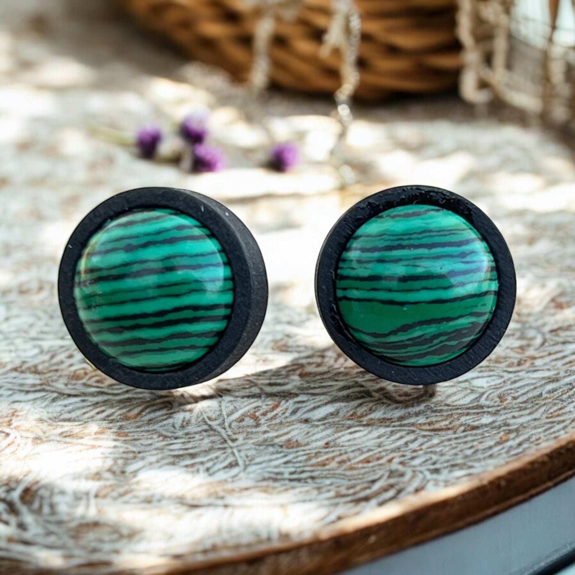 Back view of unisex wood jewelry earrings with green cabochon