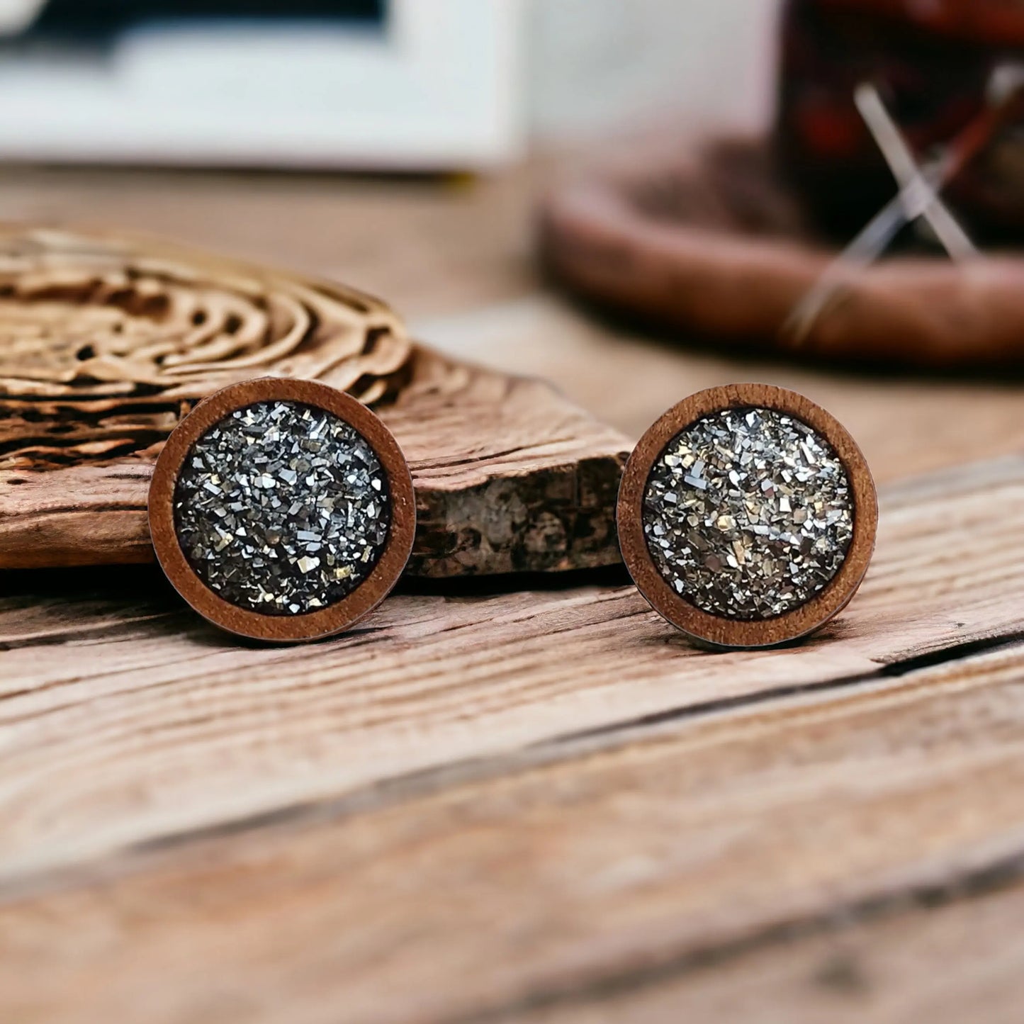 Round gunmetal gray druzy wood stud earrings displayed on a wood surface
