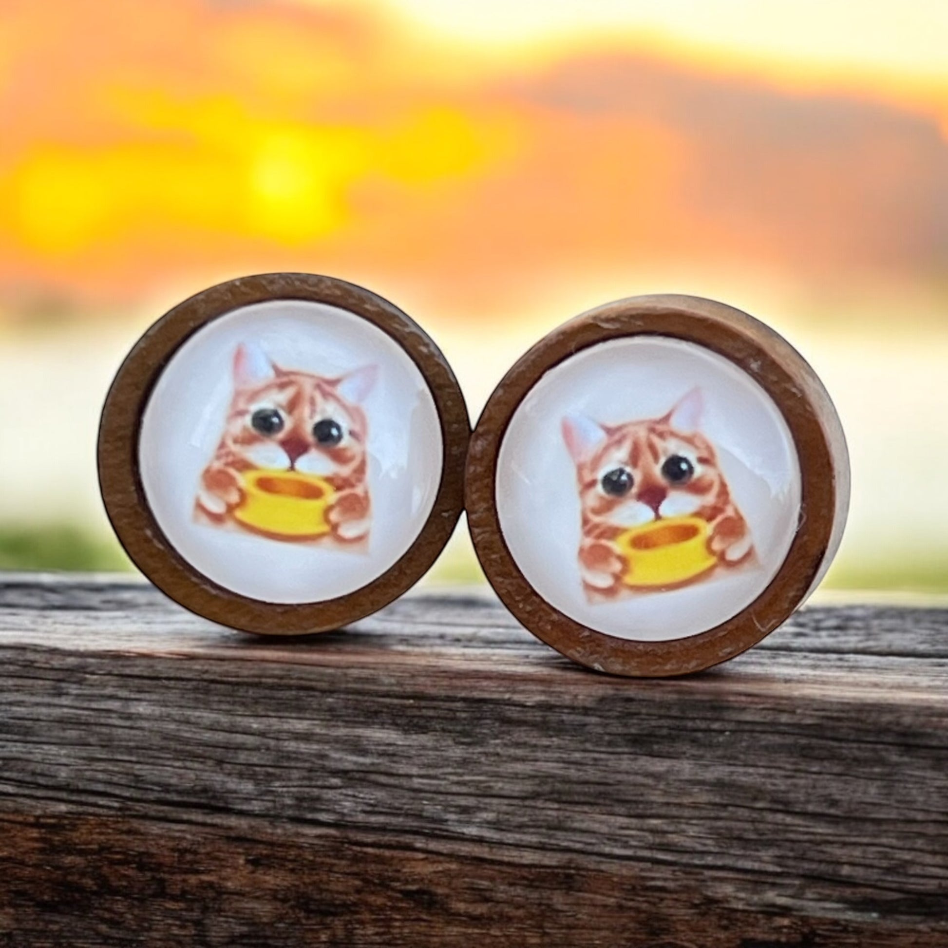 Handmade hungry cat stud earrings on brown card display