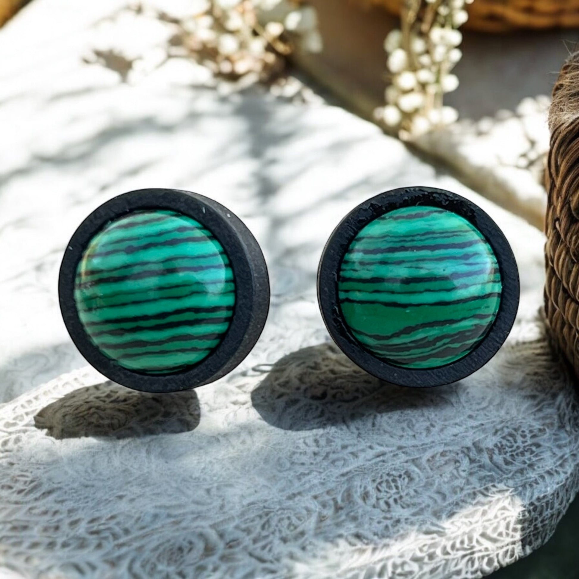 Side view of handmade wood earrings with stainless steel posts
