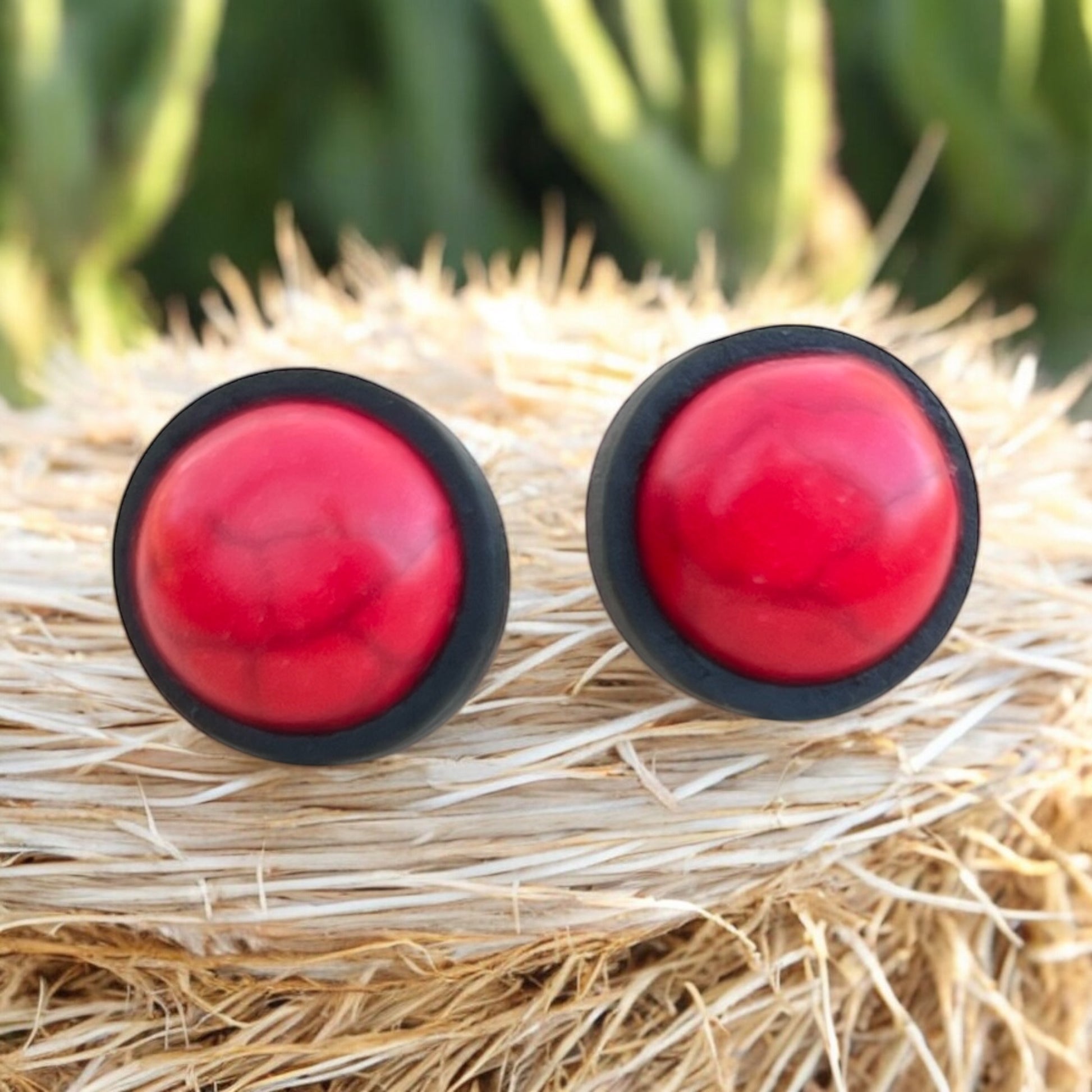 Side view of handmade red stone earrings with stainless steel posts