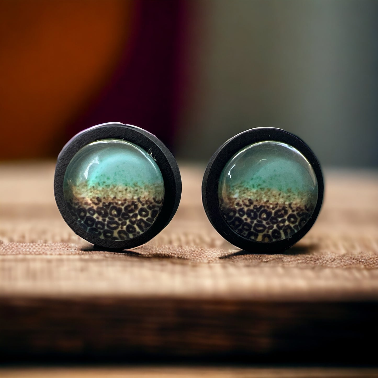Turquoise Leopard Fade Resin Stud Earrings – Bold Handmade Boho Jewelry on blurred wood.