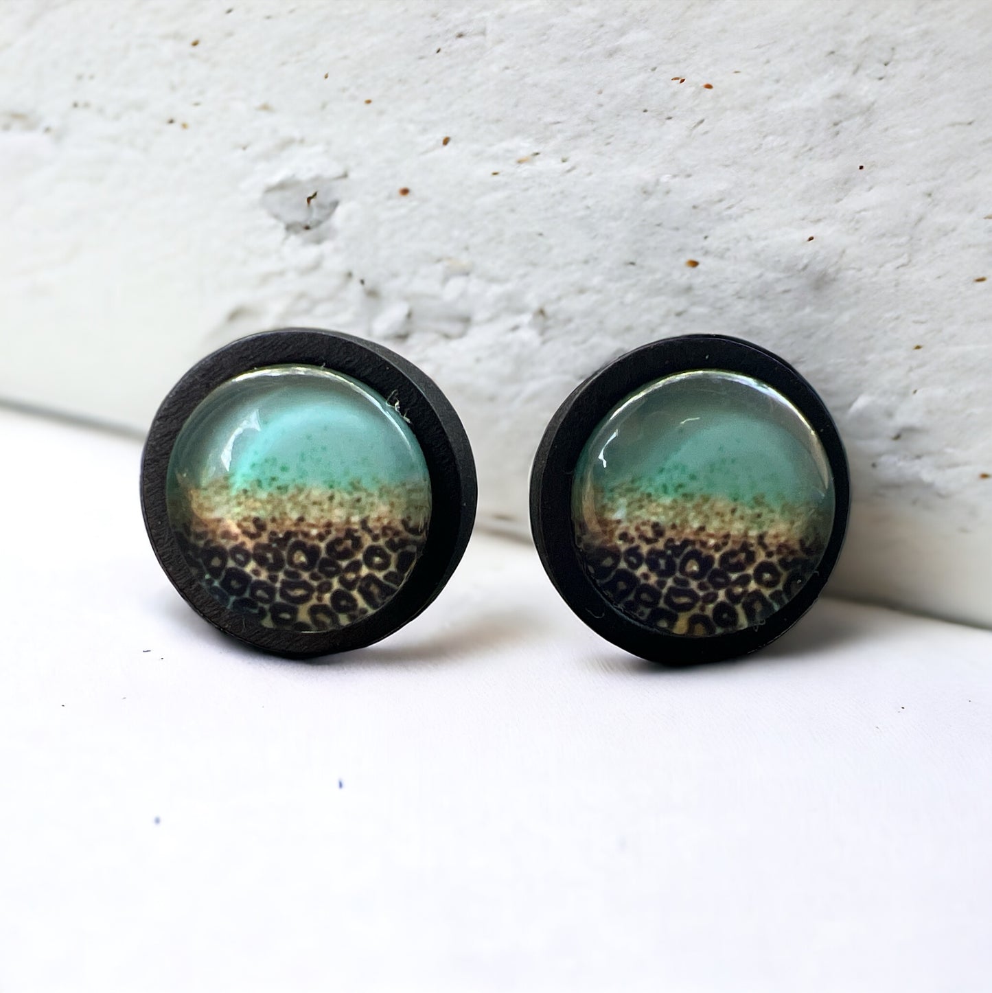 Turquoise Leopard Fade Resin Stud Earrings – Bold Handmade Boho Jewelry on white concrete.