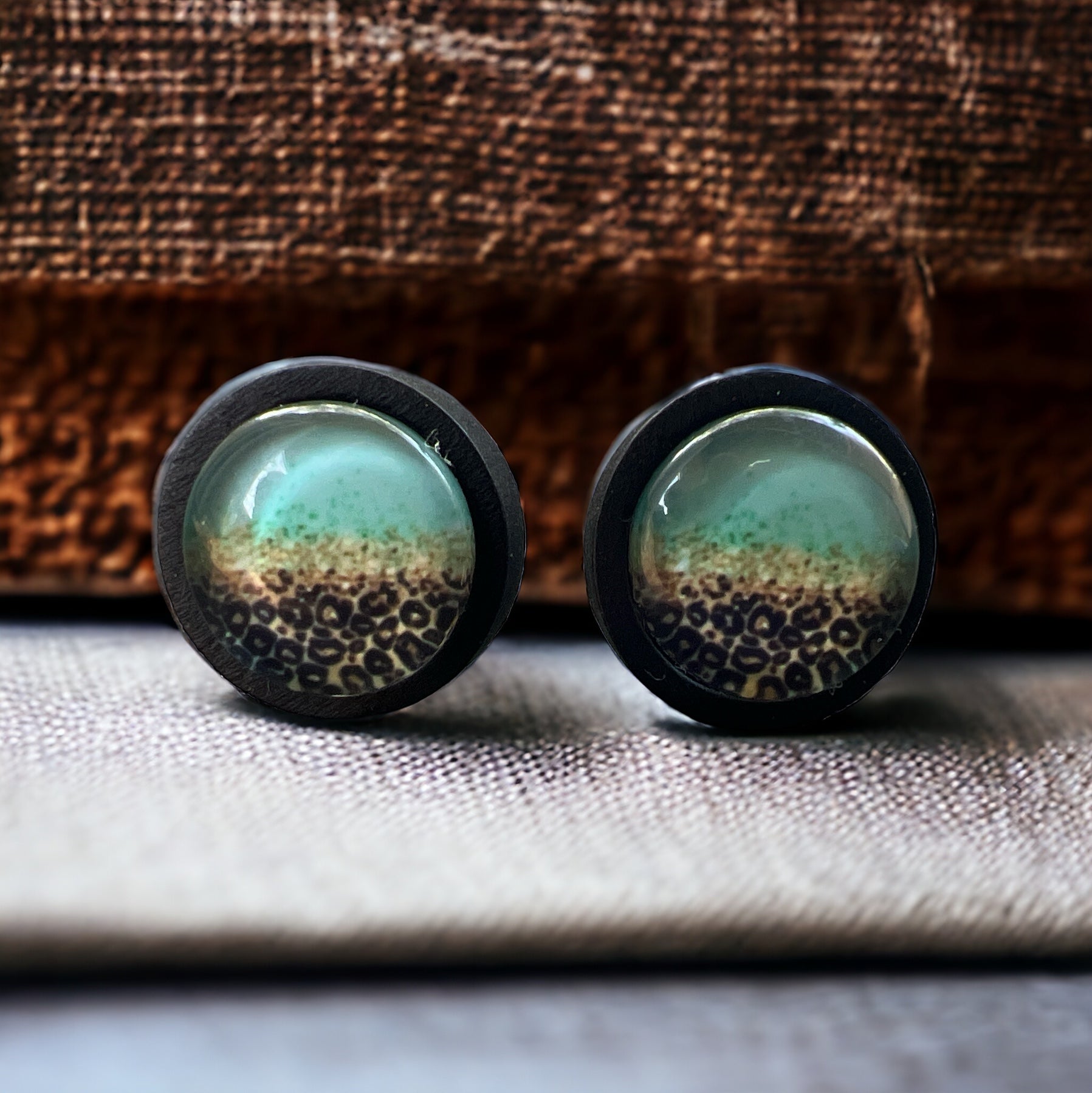 Turquoise Leopard Fade Resin Stud Earrings – Bold Handmade Boho Jewelry on brown and neutral textured linen