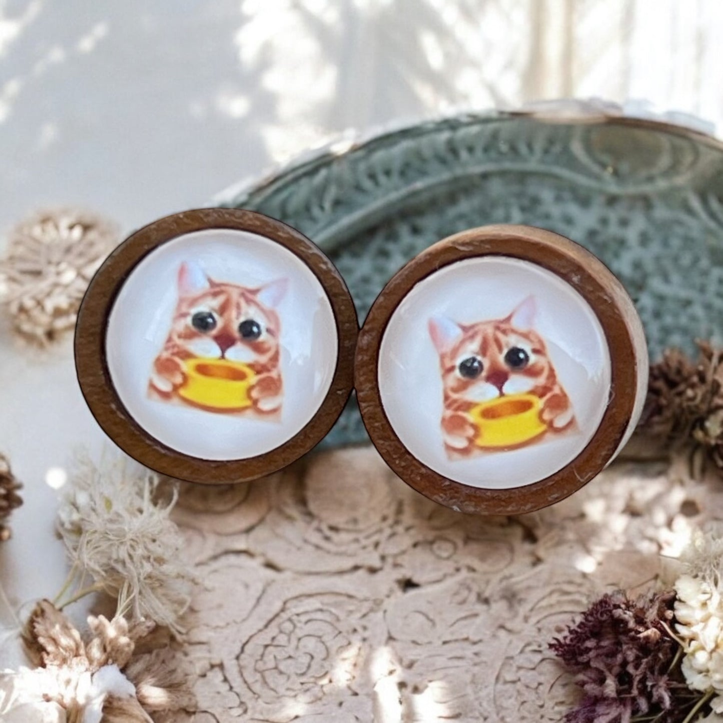 Side view of quirky cat studs with stainless steel posts