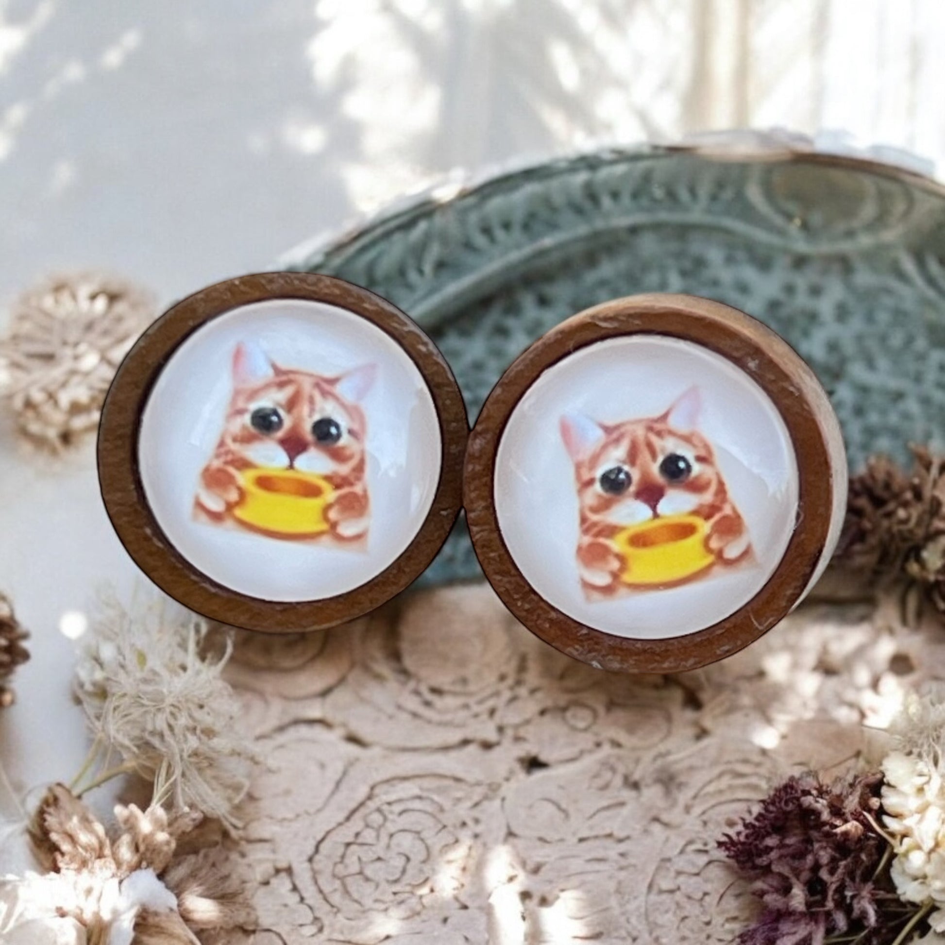 Side view of quirky cat studs with stainless steel posts