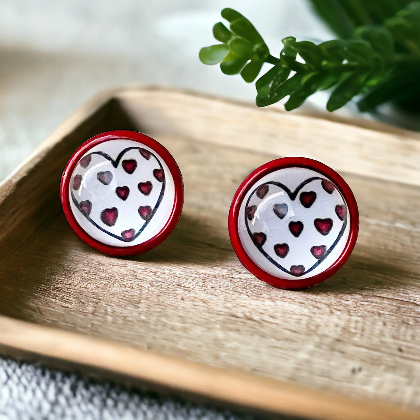 Red & White Heart Stud Earrings on a decorative wooden tray