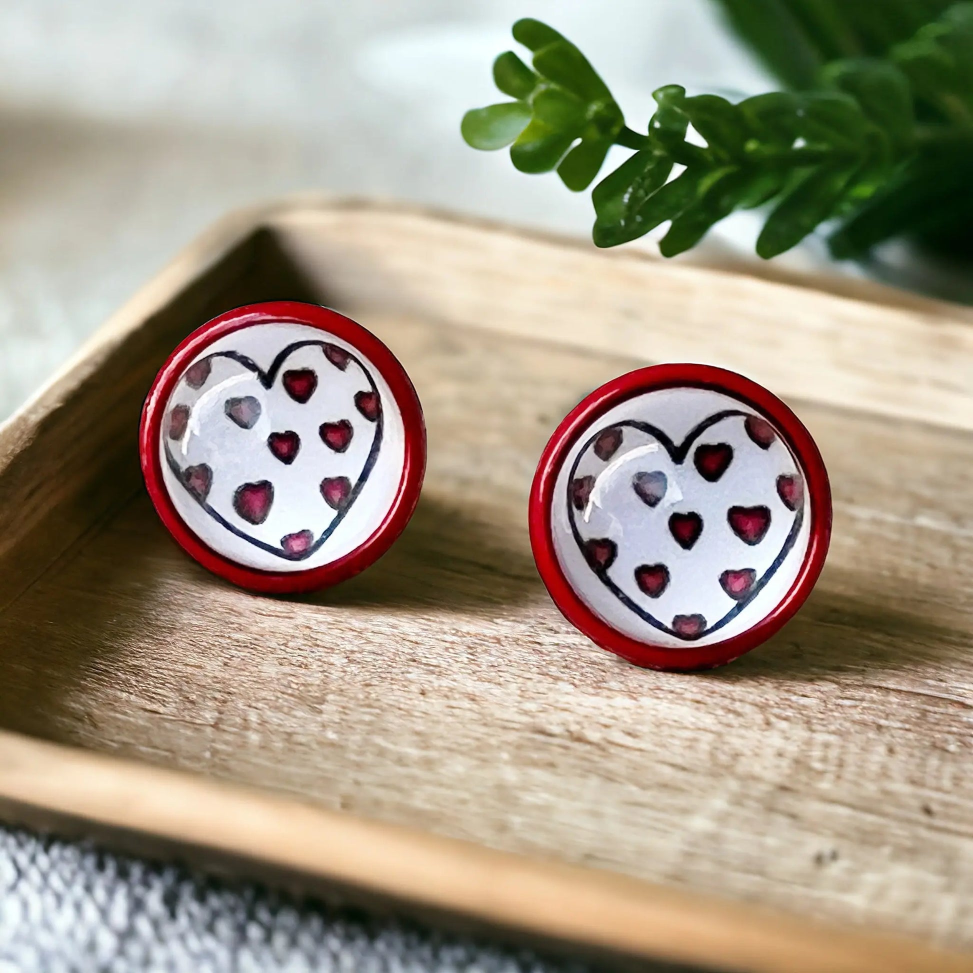 Red & White Heart Stud Earrings on a decorative wooden tray