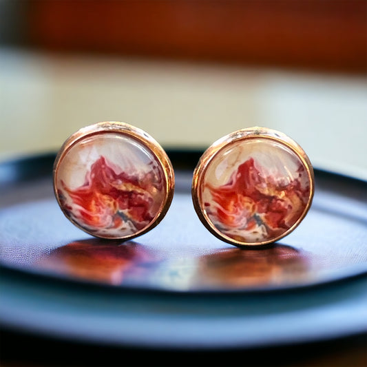 Rose gold bezel stud earrings with glossy marbled resin in red, blush, and white