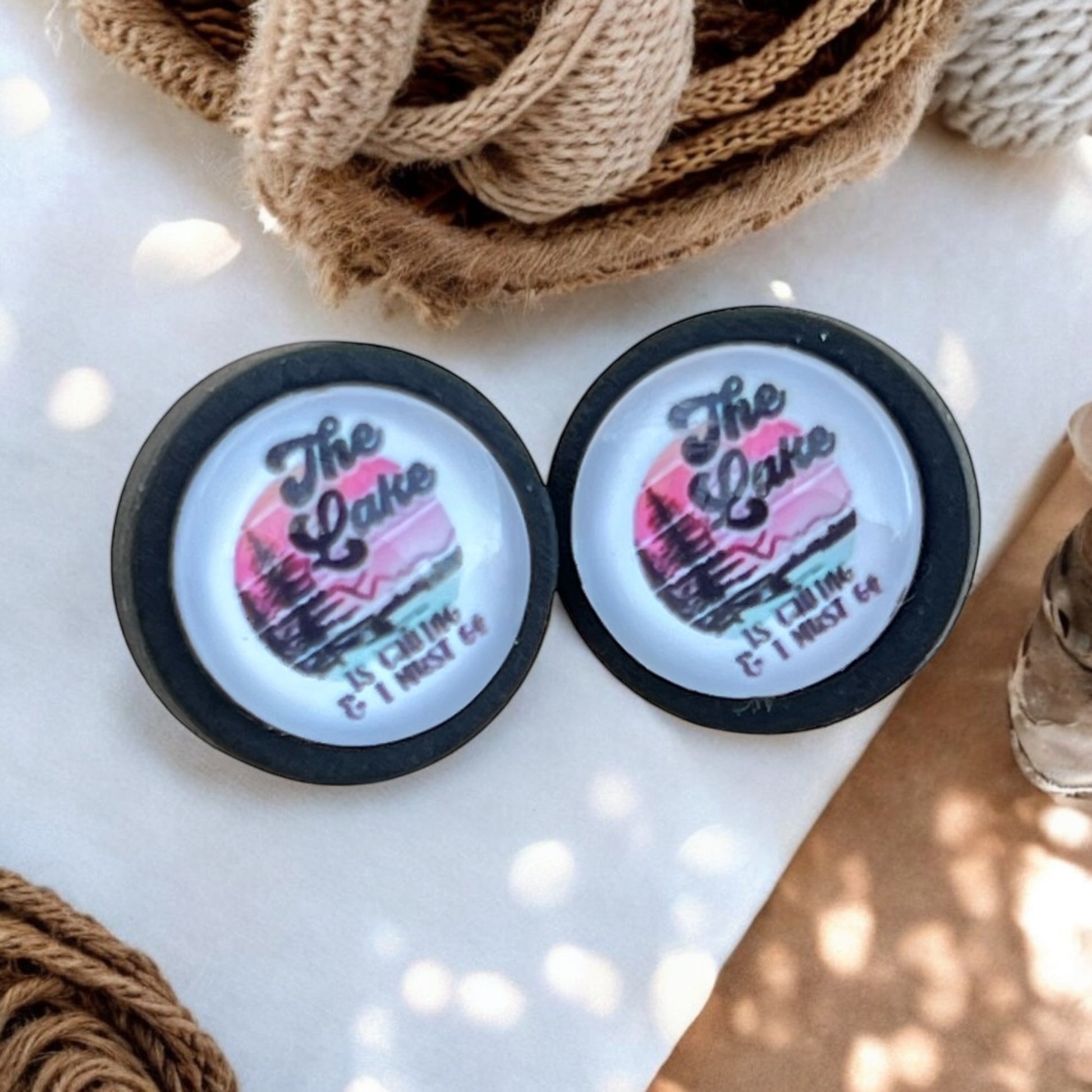 Handmade rustic lake earrings on wood background with cozy outdoor vibe