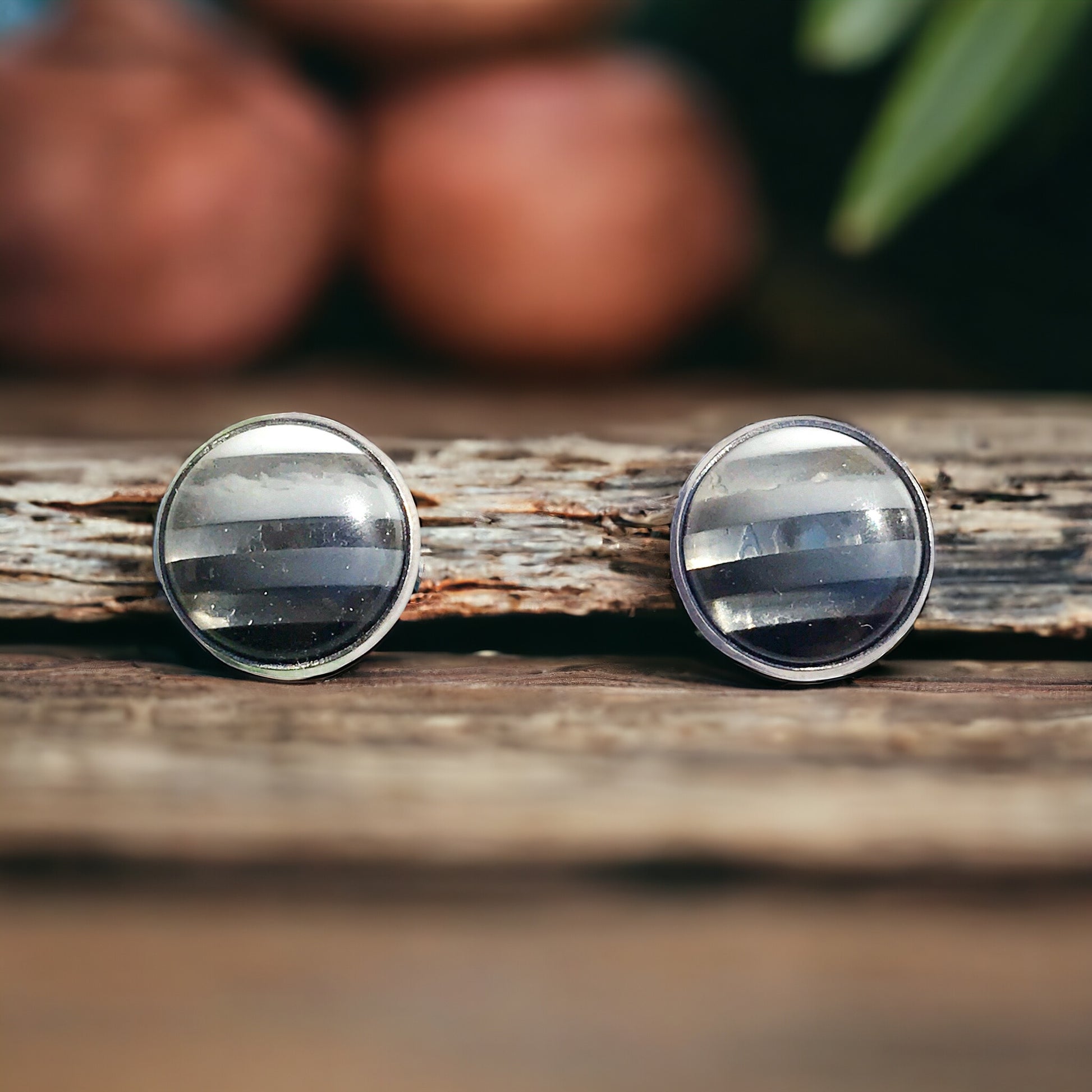Modern handmade stud earrings styled with minimal props