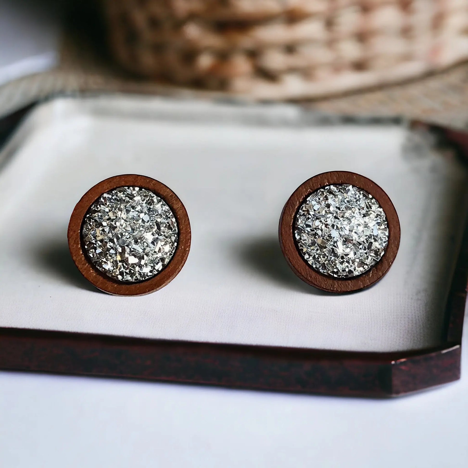 Round silver druzy wood stud earrings displayed on a white tray