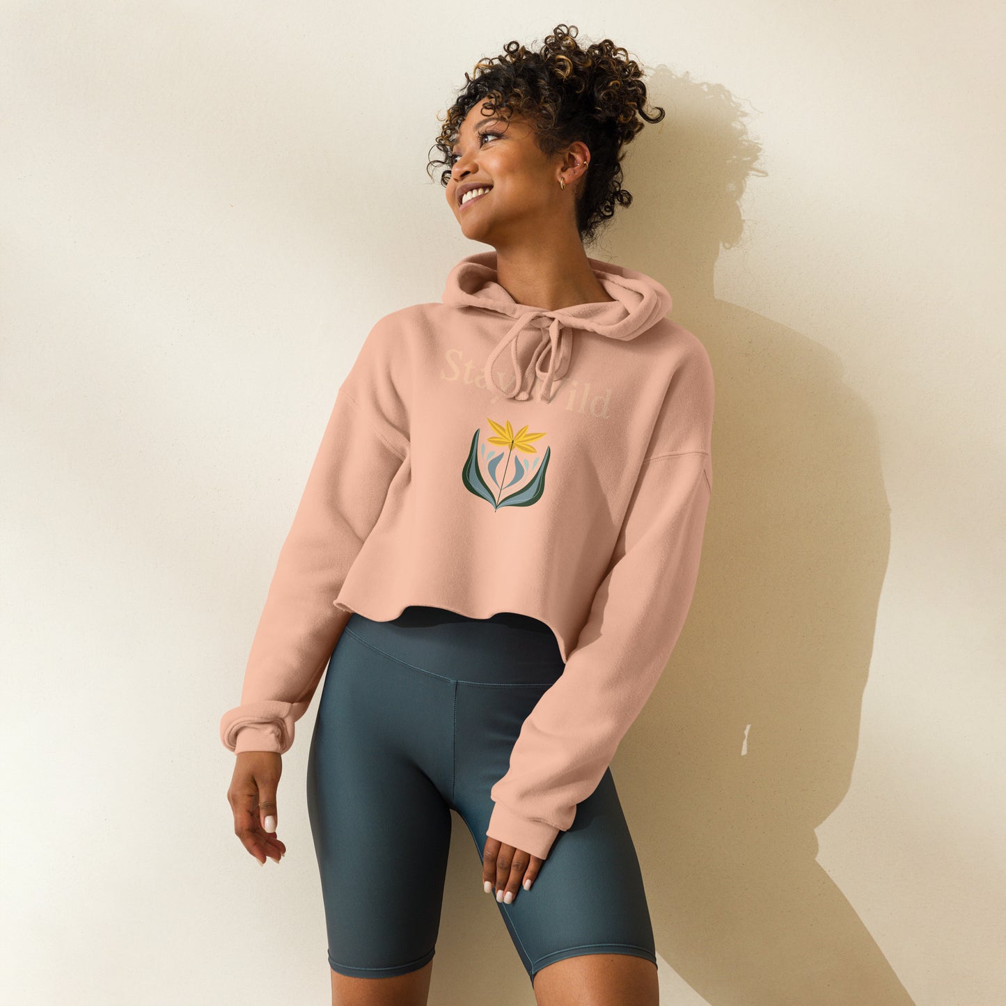 Side view of peach boho crop hoodie with Stay Wild floral graphic