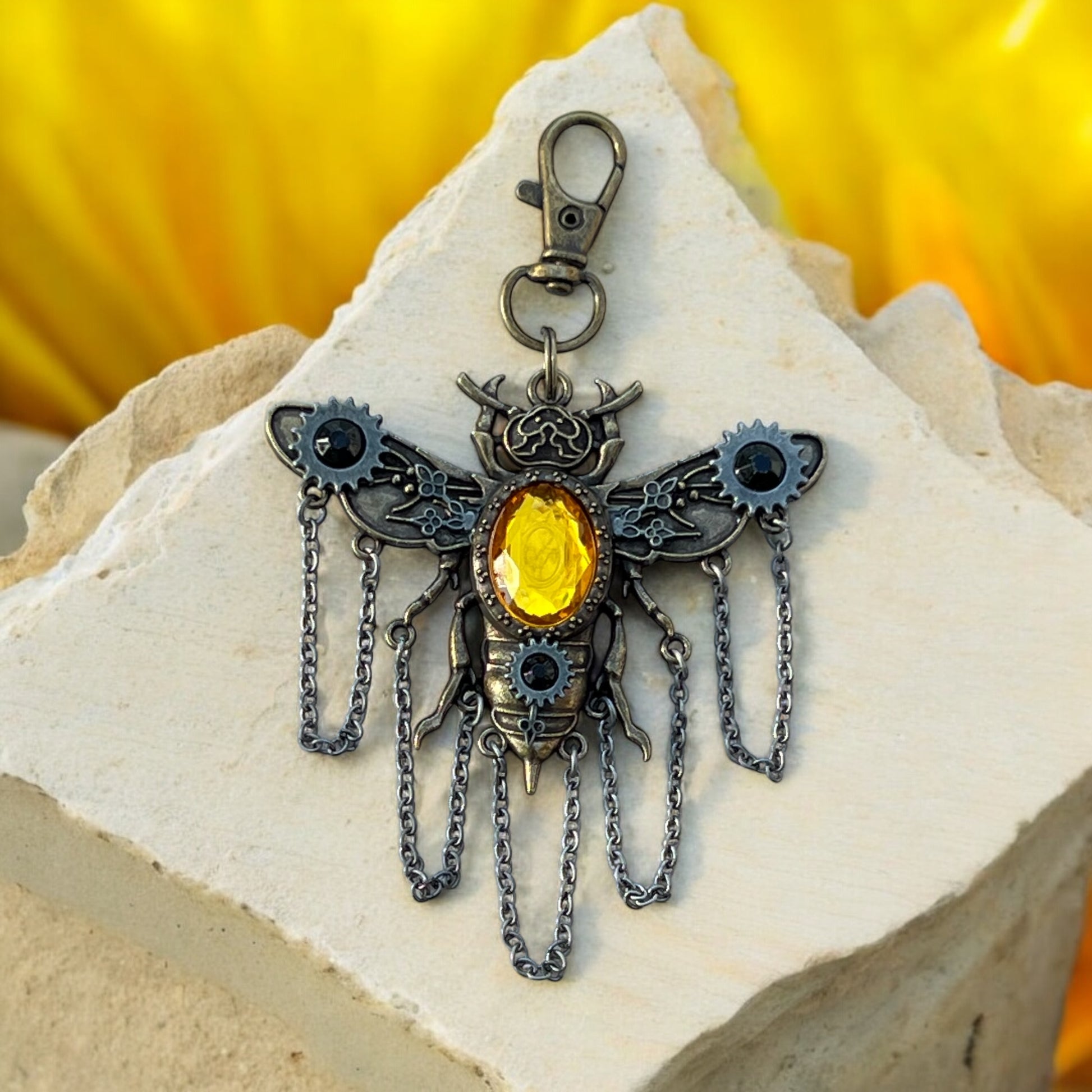 Close-up of steampunk bee charm with mechanical gear details