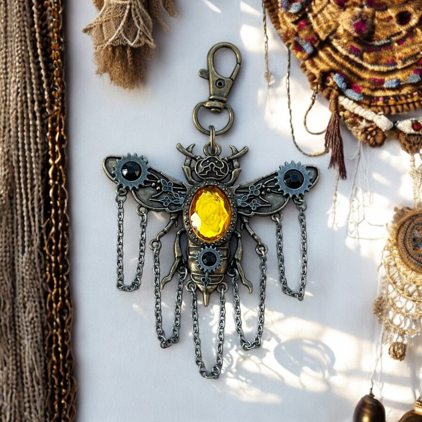 Steampunk bee purse charm with gears and wings on vintage background