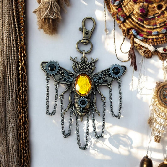 Steampunk bee purse charm with gears and wings on vintage background