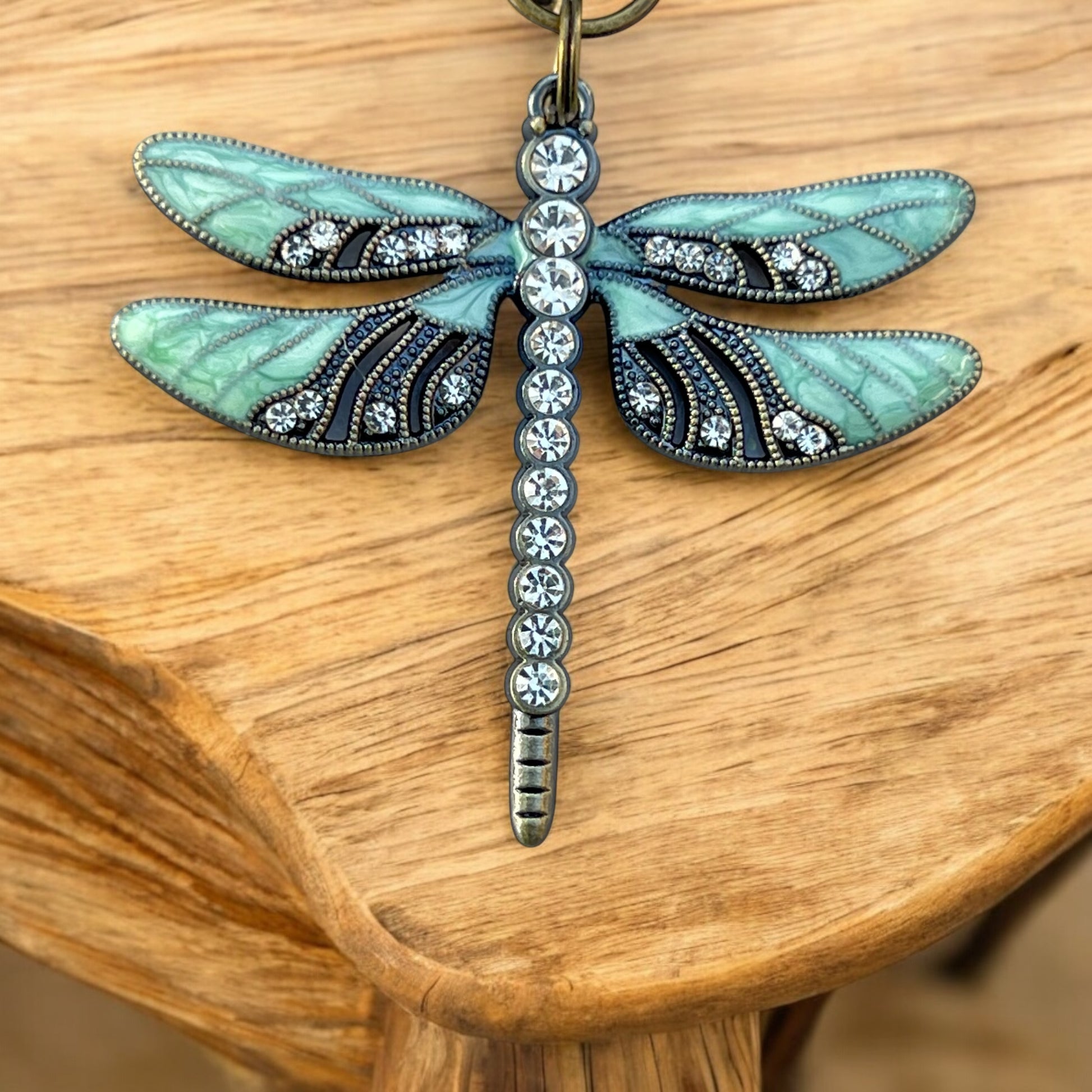 Close-up of steampunk dragonfly keychain with antique brass finish